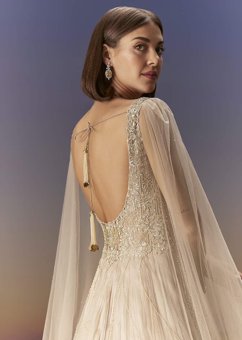 Gold Gown With Pleated Panels And Dramatic Cape - Image 6